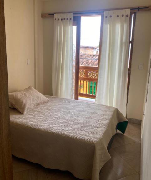 a bedroom with a bed and a large window at APARTAMENTO LOLACELE in Jardin