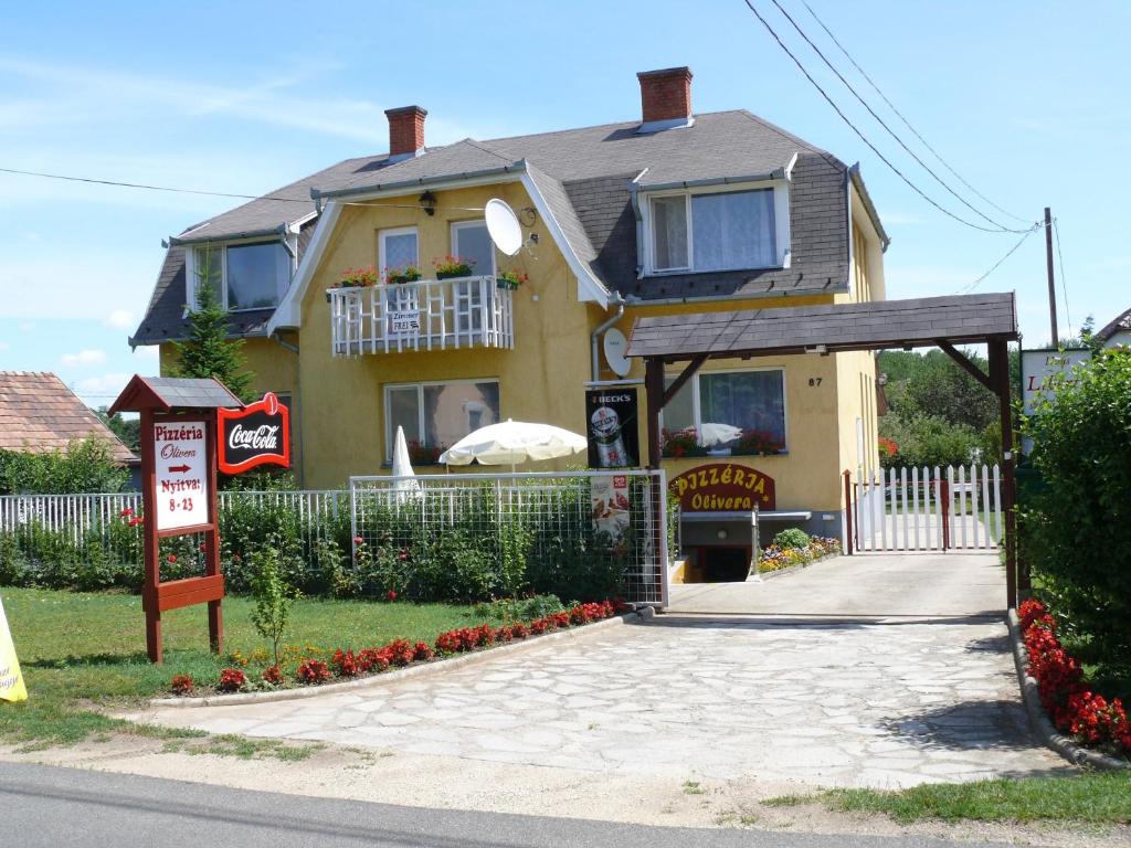 a house with a sign in front of it at Haus Liberty in Balatonlelle