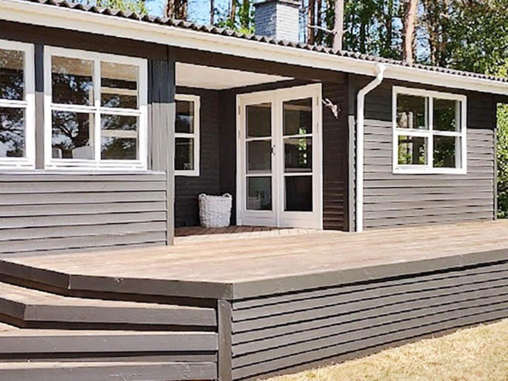 a small house with a porch and a deck at 6 person holiday home in Bording-By Traum in Bording Stationsby