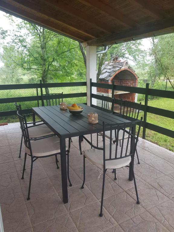 a black table and chairs on a patio at In the nature by Marko in Benkovac