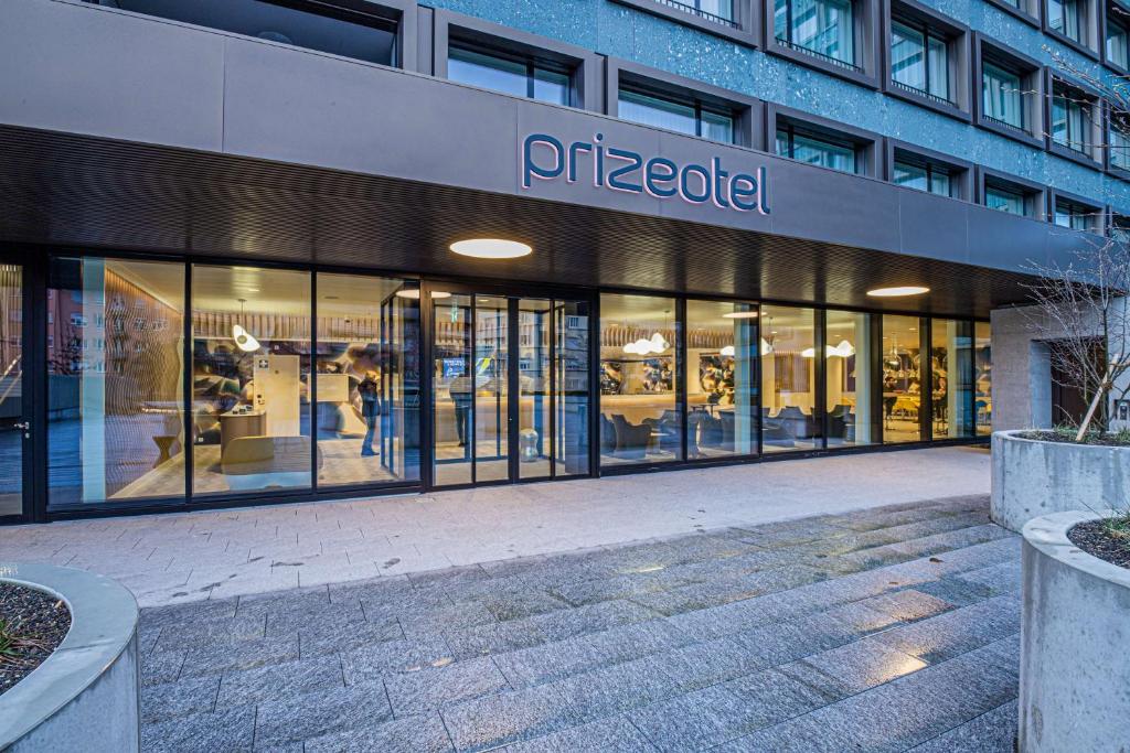 a store front of a building with glass windows at prizeotel Bern-City in Bern