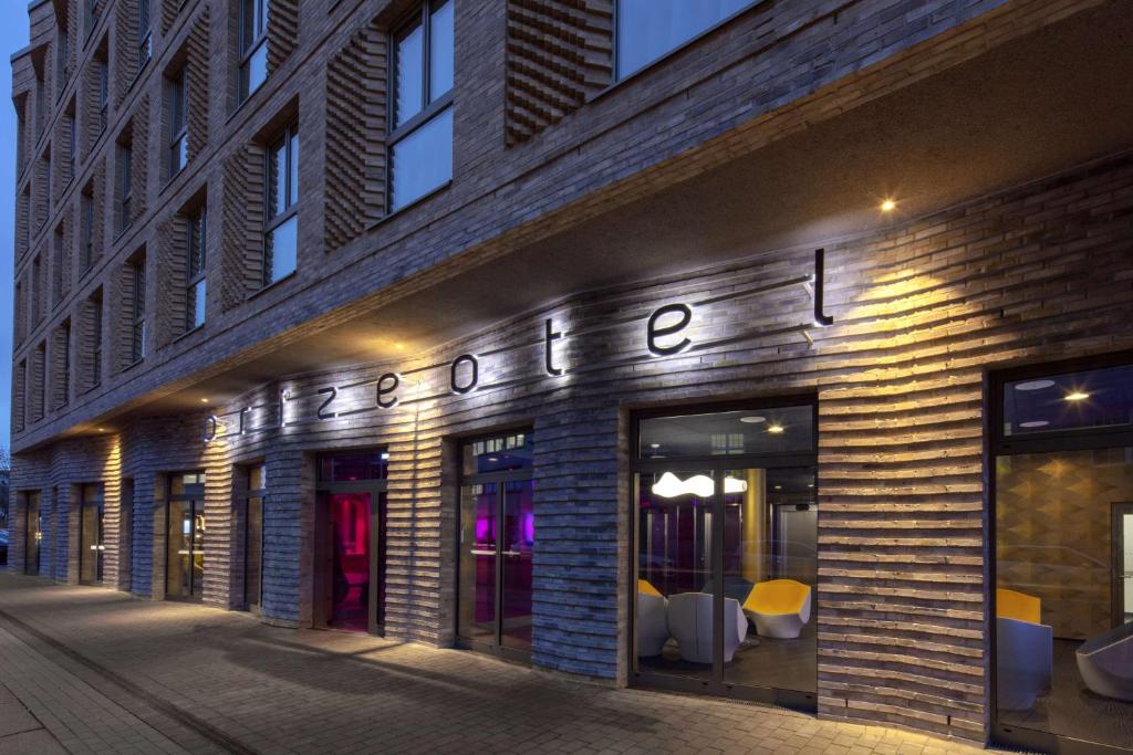 a store with a sign on the side of a building at prizeotel Erfurt-City in Erfurt