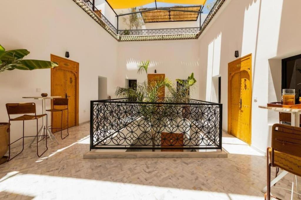 a room with a balcony with plants in it at Riad Olika in Marrakech