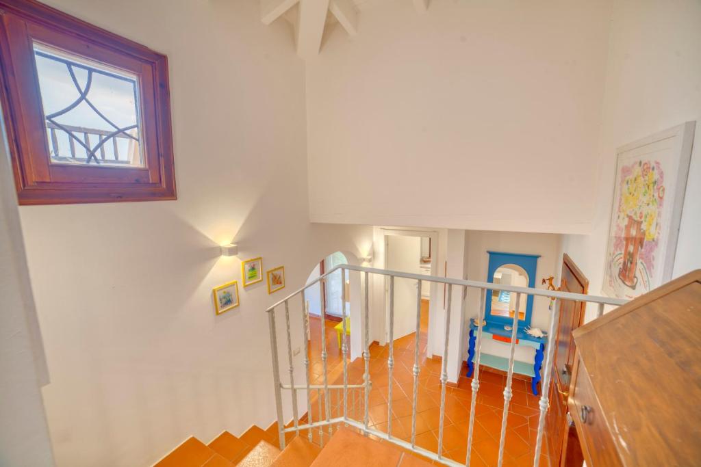 Postel nebo postele na pokoji v ubytování Villa Hibiscus Stintino