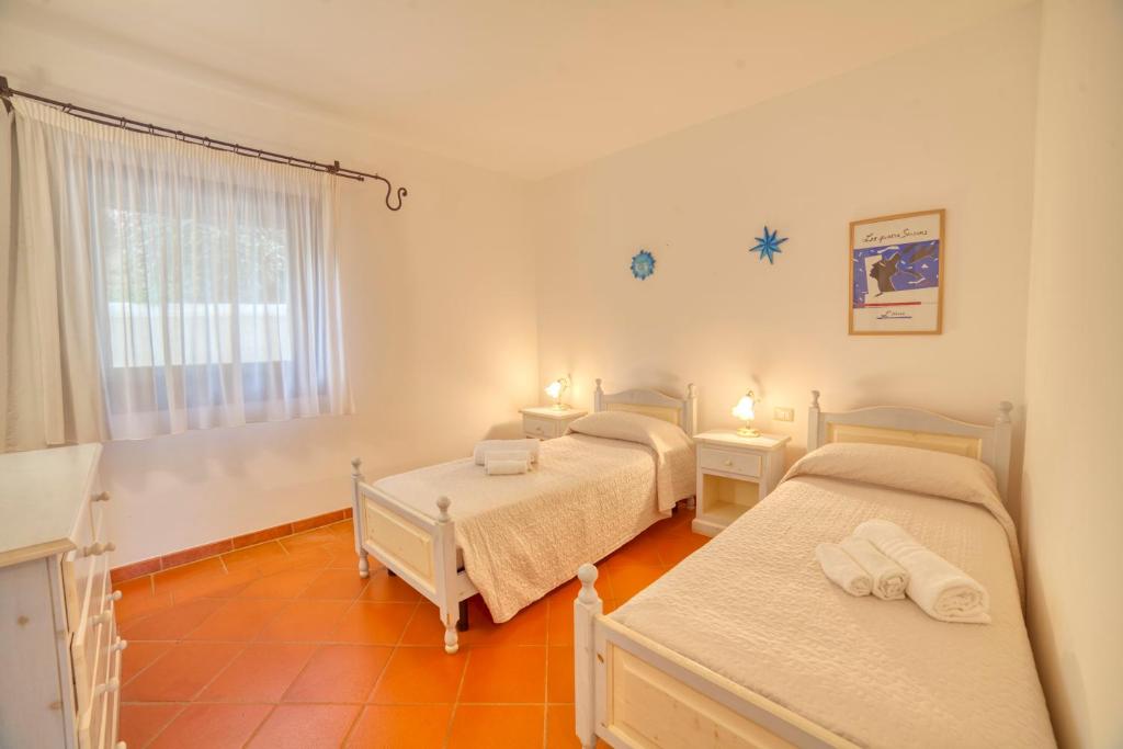Postel nebo postele na pokoji v ubytování Villa Hibiscus Stintino