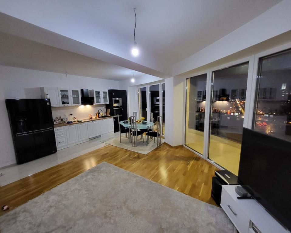 a living room with a kitchen and a dining room at Mr.-Legend's Penthouse in Skopje