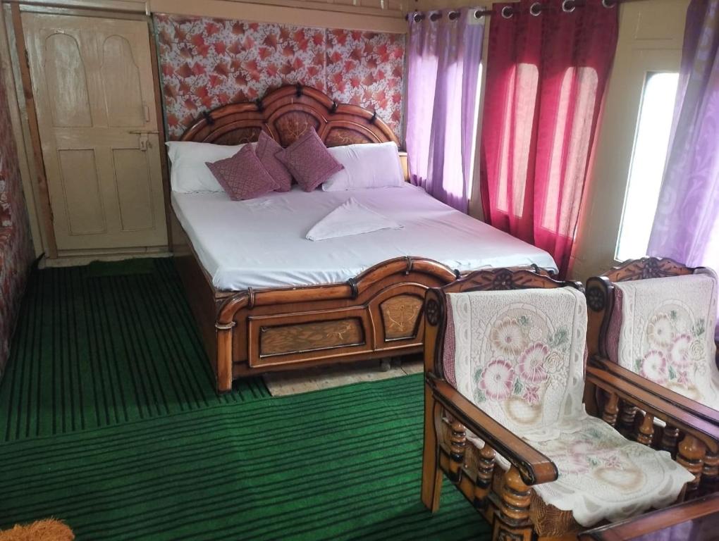 a bedroom with a wooden bed with two chairs at Midway Home stay in Jibhi