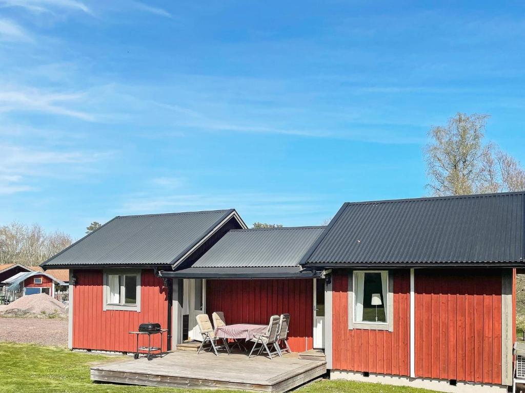 uma casa vermelha com uma mesa e cadeiras em frente em Holiday home GRÄNNA VI em Gränna