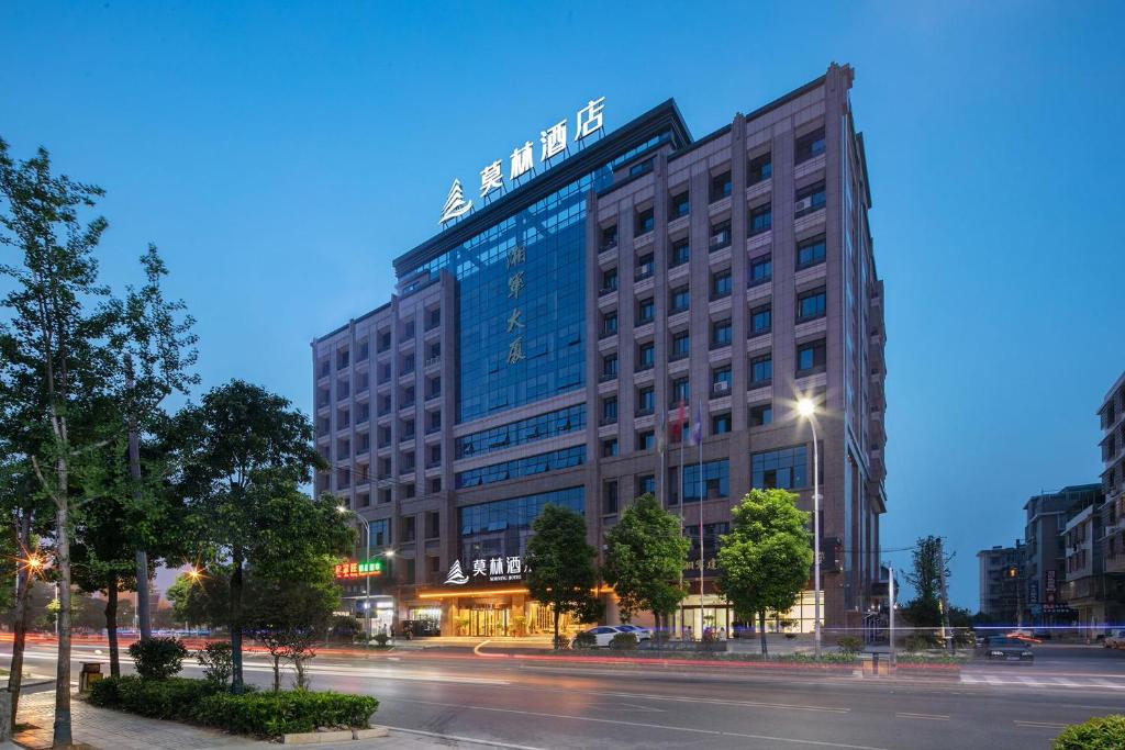 ein großes Gebäude in der Nacht auf einer Stadtstraße in der Unterkunft Morning Hotel, Xiangxiang in Xiangtan