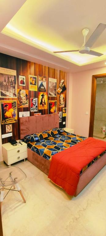 a bedroom with a bed and posters on the wall at Vinanda Home Stay in New Delhi