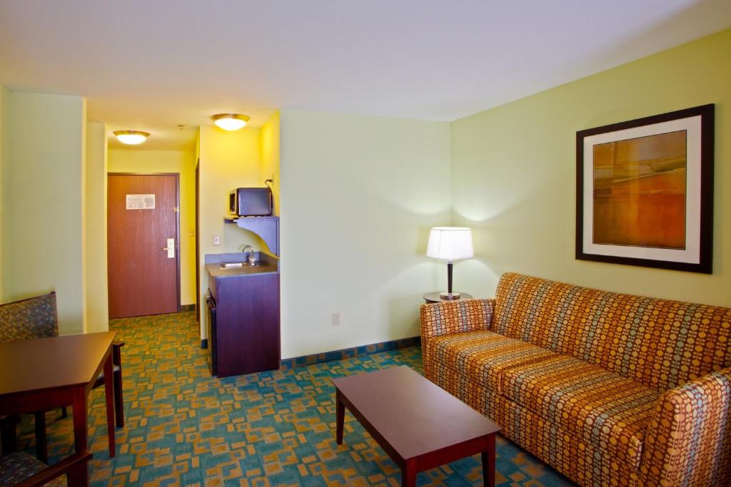 a living room with a couch and a table at Holiday Inn Express Hotel & Suites Thornburg-S. Fredericksburg, an IHG Hotel in Thornburg