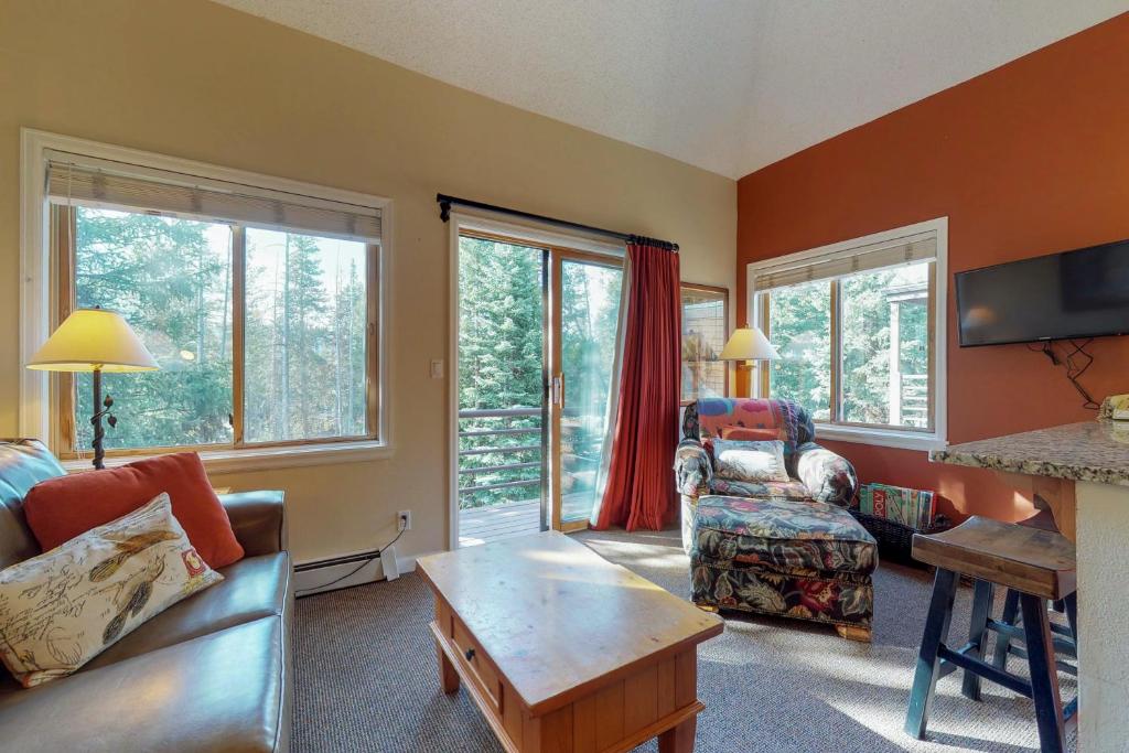 a living room with a couch and a table at Year Round Getaway 301 in Breckenridge