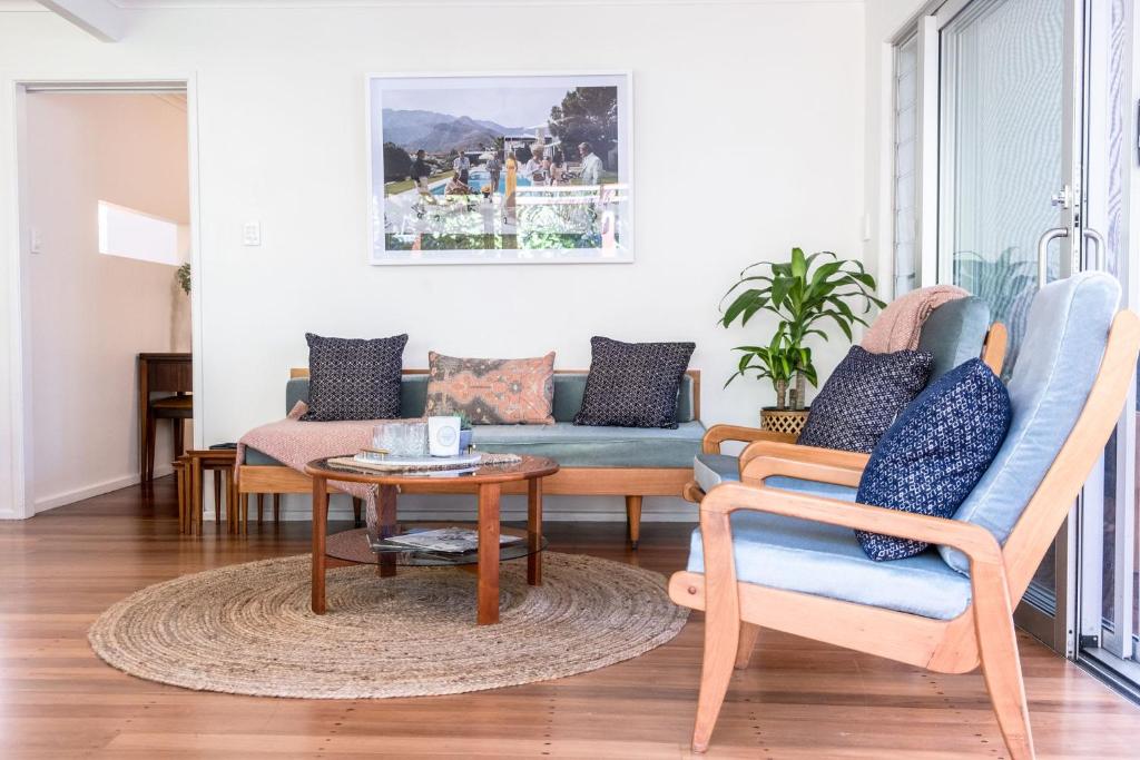 a living room with a couch and a table at Mid-Century Modern Retro Beach House in Caloundra
