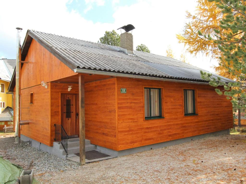 a small wooden cabin with a roof at Sunlit Cabin with Jacuzzi in Turracherhohe in Turracher Hohe