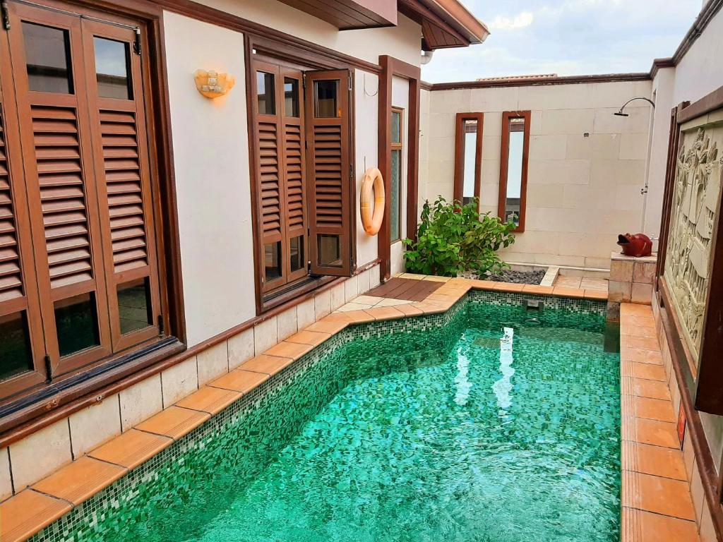 a swimming pool in the backyard of a house at Wonderland Private Pool Villas at Port Dickson in Port Dickson