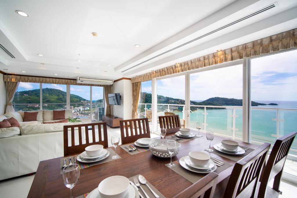 a dining room with a table and a large window at Patongtower Duplex Seaview4BR2902 in Patong Beach