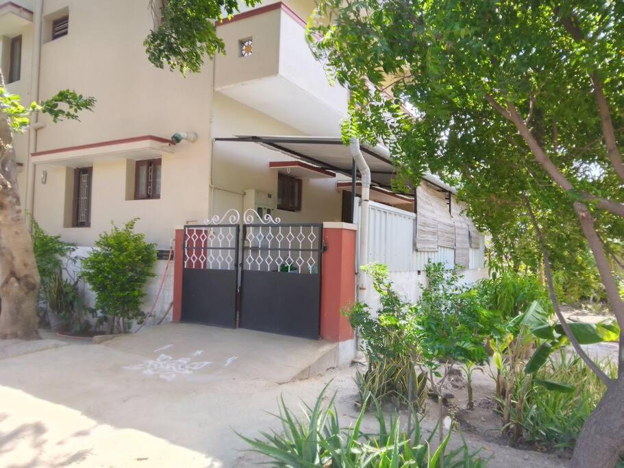 a house with a gate in front of it at Aathira's 2 Bedroom house @ Heart of Coimbatore in Coimbatore