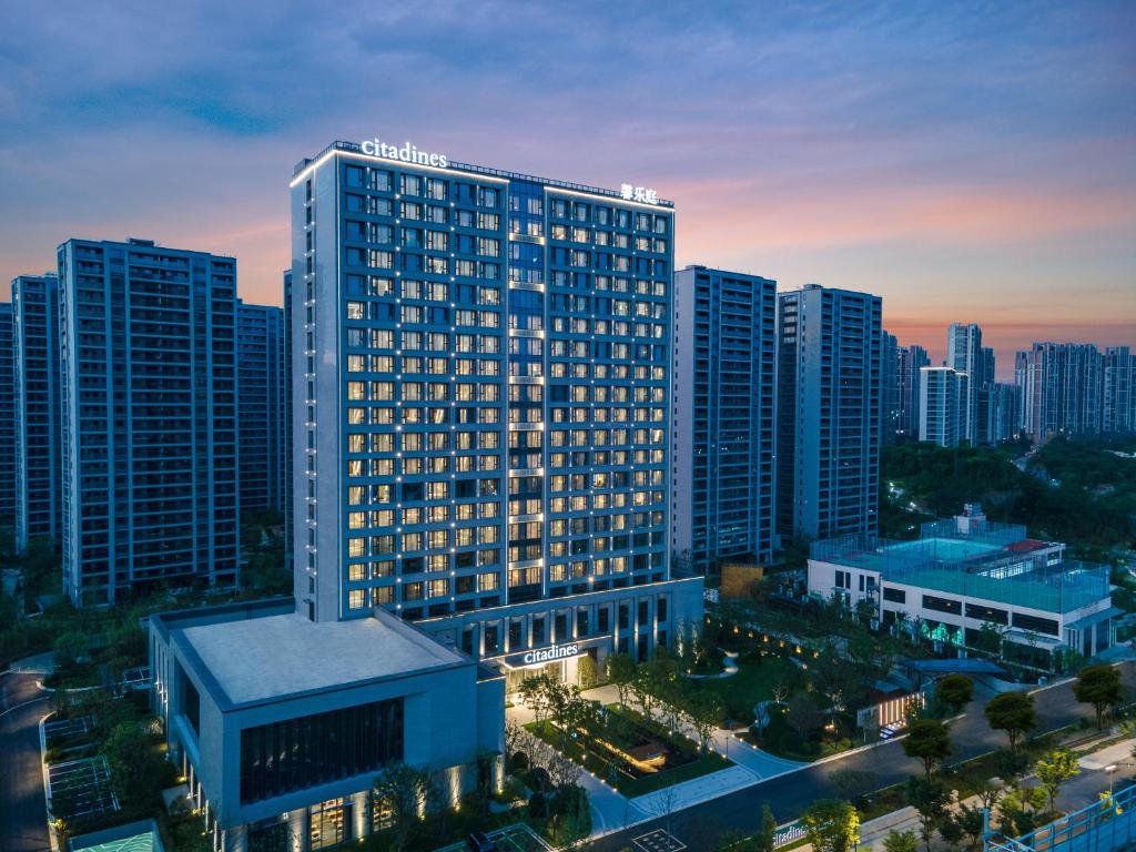 a large building in a city with tall buildings at Citadines Qingshanhu Hangzhou in Hangzhou