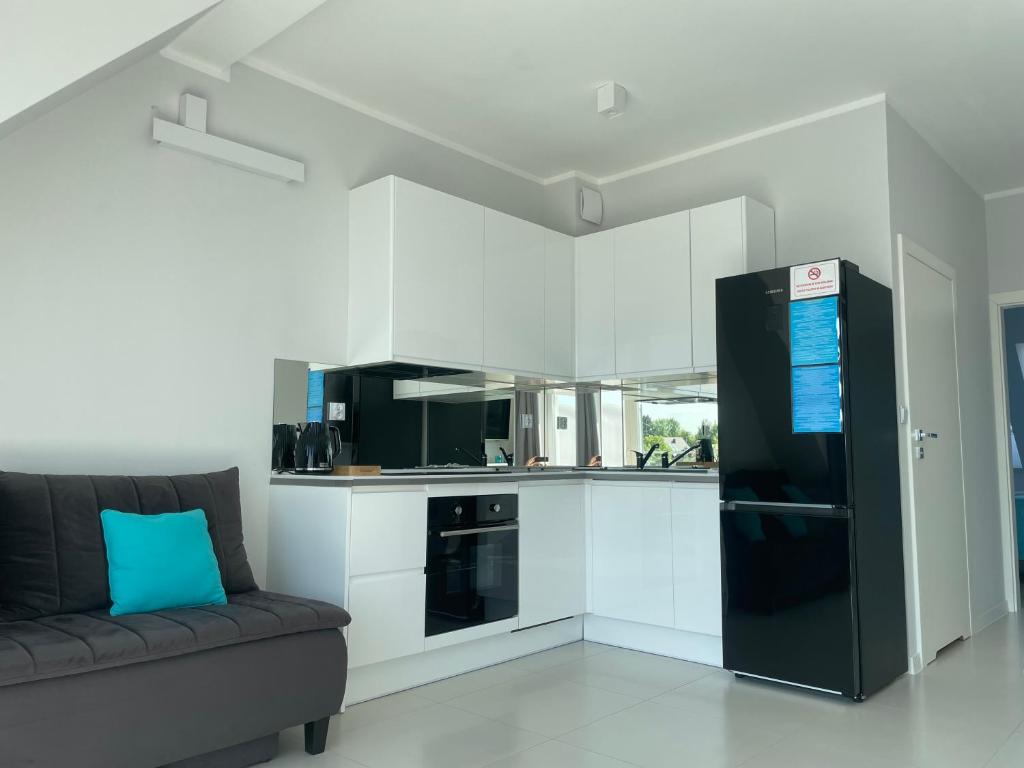 Kuchyňa alebo kuchynka v ubytovaní Apartamenty AQUA MAZURY