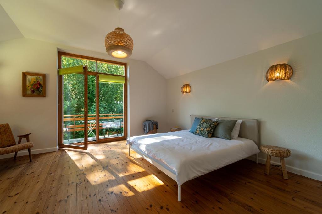 a bedroom with a bed and a large window at Your Seaside Villa in Jurmala in Jūrmala