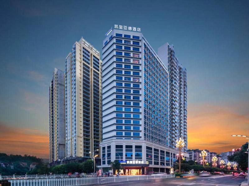 a tall building with many windows in a city at Kyriad Marvelous Hotel Guizhou Dujun Center Wanda Plaza in Duyun