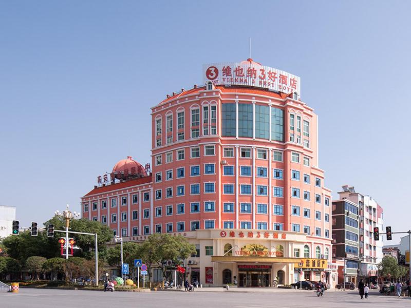 ein großes rotes Gebäude an der Ecke einer Straße in der Unterkunft Vienna SanHao Hotels Yichun Gao'an Avenue in Gao'an