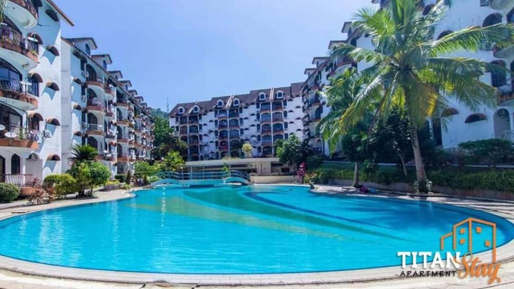a large swimming pool in front of some apartment buildings at SERI LAGENDA 4 in Kuah