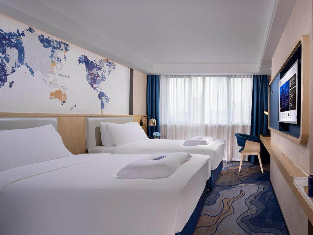 Postel nebo postele na pokoji v ubytování Kyriad Hotel Zhongshan University of Science and Technology
