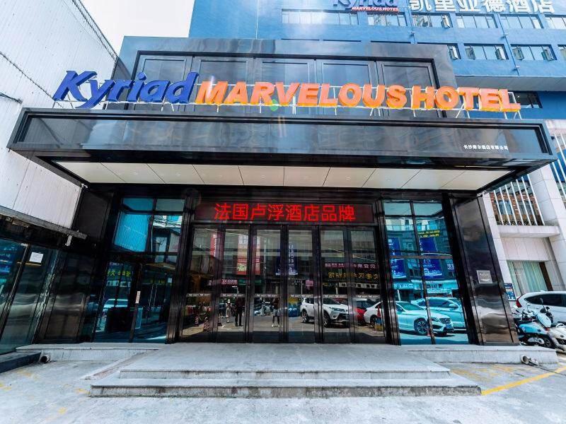 a building with a sign on the front of it at Kyriad Marvelous Hotel Changsha Xiangya in Changsha