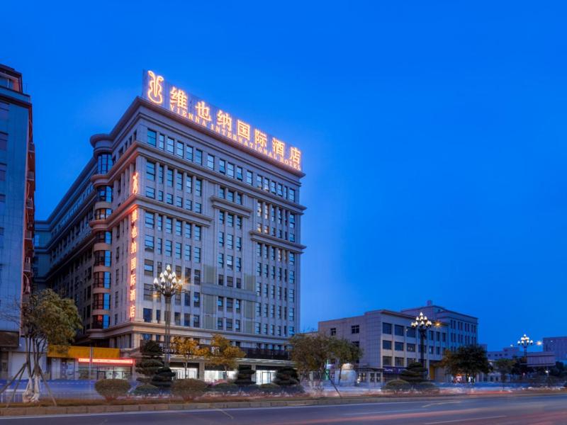 a large building with lights on the top of it at Vienna International Hotel Fujian Quanzhou Jinjiang Airport in Jinjiang