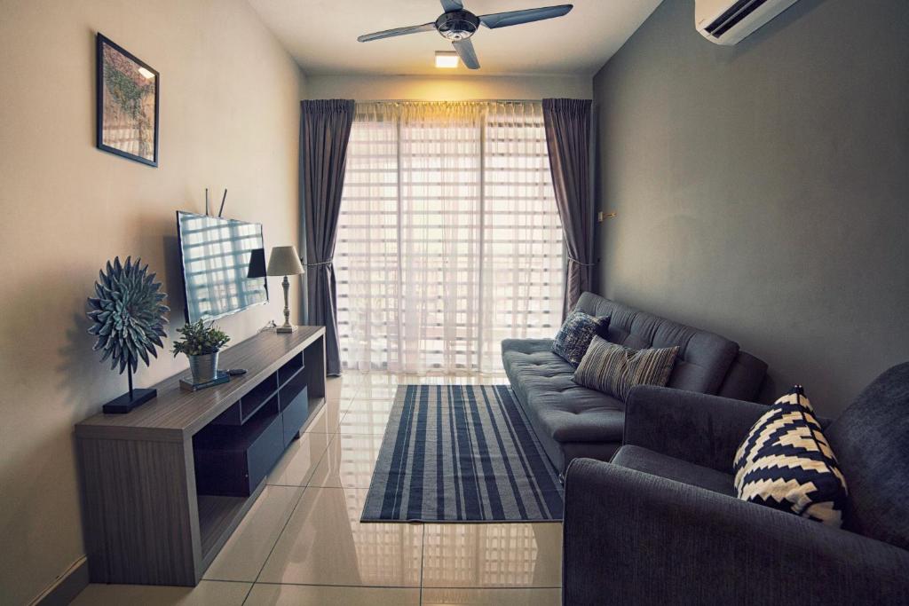 a living room with a couch and a large window at The Majestic-Loft De Tel in Ipoh