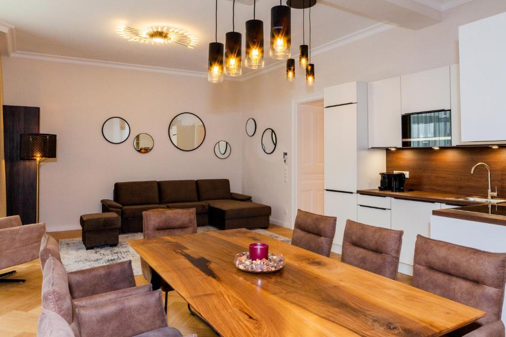 Il dispose d'une cuisine et d'un salon avec une table et des chaises en bois. dans l'établissement Vienna Stay Apartments Taborstrasse, à Vienne