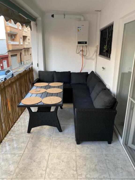 a living room with a couch and a table at Beautiful apartment 1 minute walk to the beach in Puerto de Sagunto