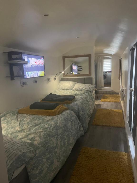 a bedroom with two beds and a flat screen tv at Quay Central in Exeter