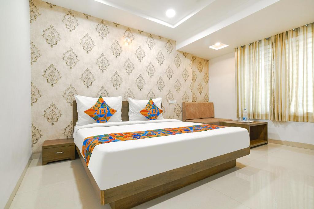 ein Schlafzimmer mit einem großen Bett in einem Zimmer in der Unterkunft FabHotel Ten Eleven in Indore