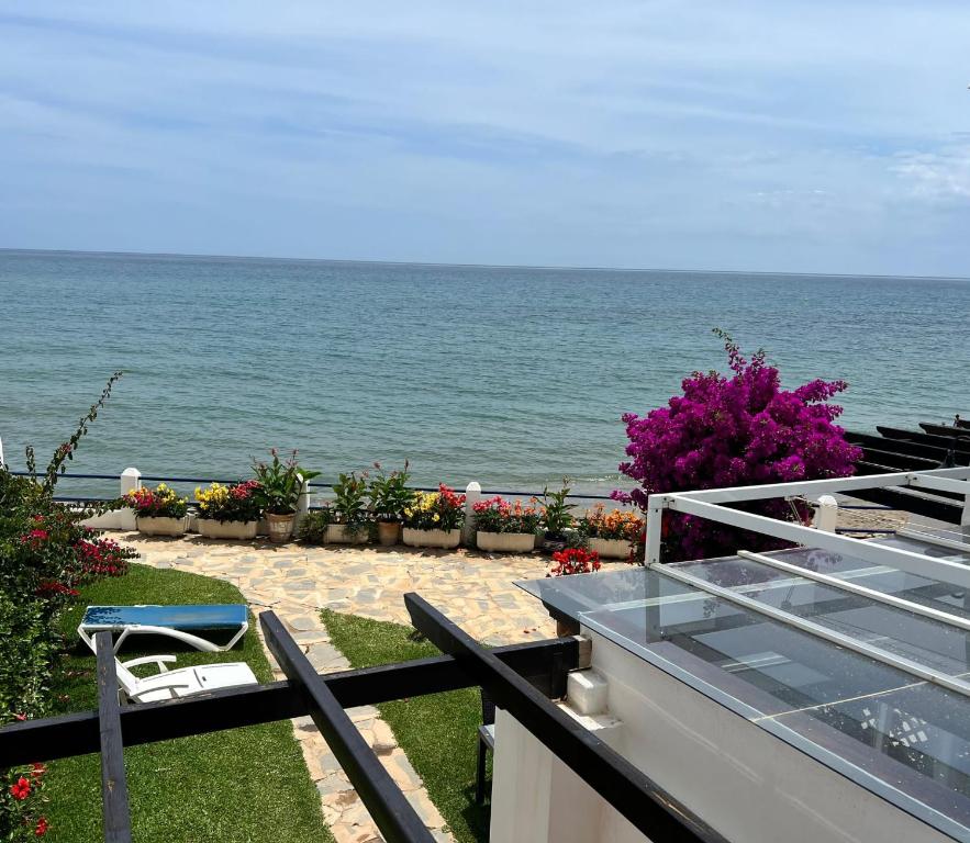 a view of the ocean from the balcony of a house at Newly Renovated 2 Bedroom Beachfront House in Sitio de Calahonda