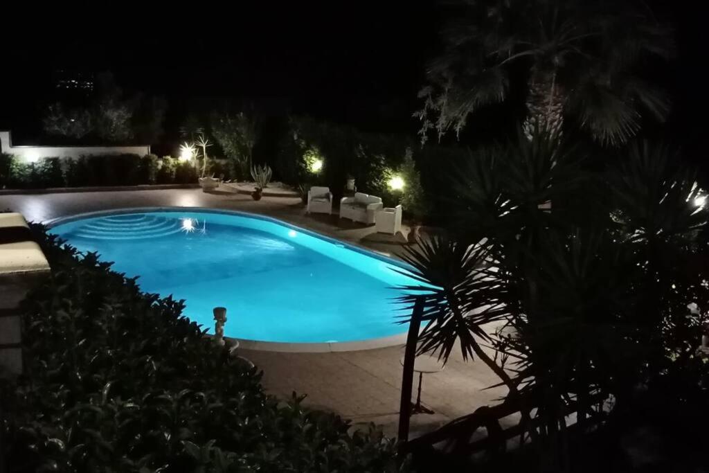 a swimming pool in a yard at night at Casa Vacanze Villa Anna in Vibo Valentia