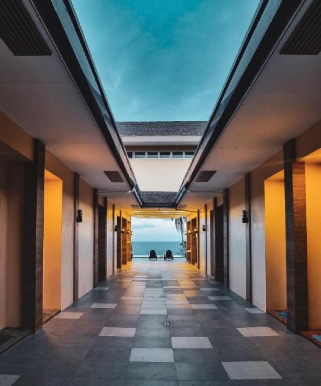 a hallway of a building with a view of the ocean at RedDoorz at Homa Resort Hotel in Camotes Islands