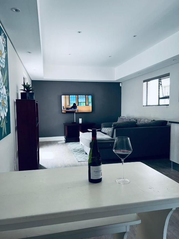 a bottle of wine sitting on a table in a living room at 6 on Western Guest House in East London