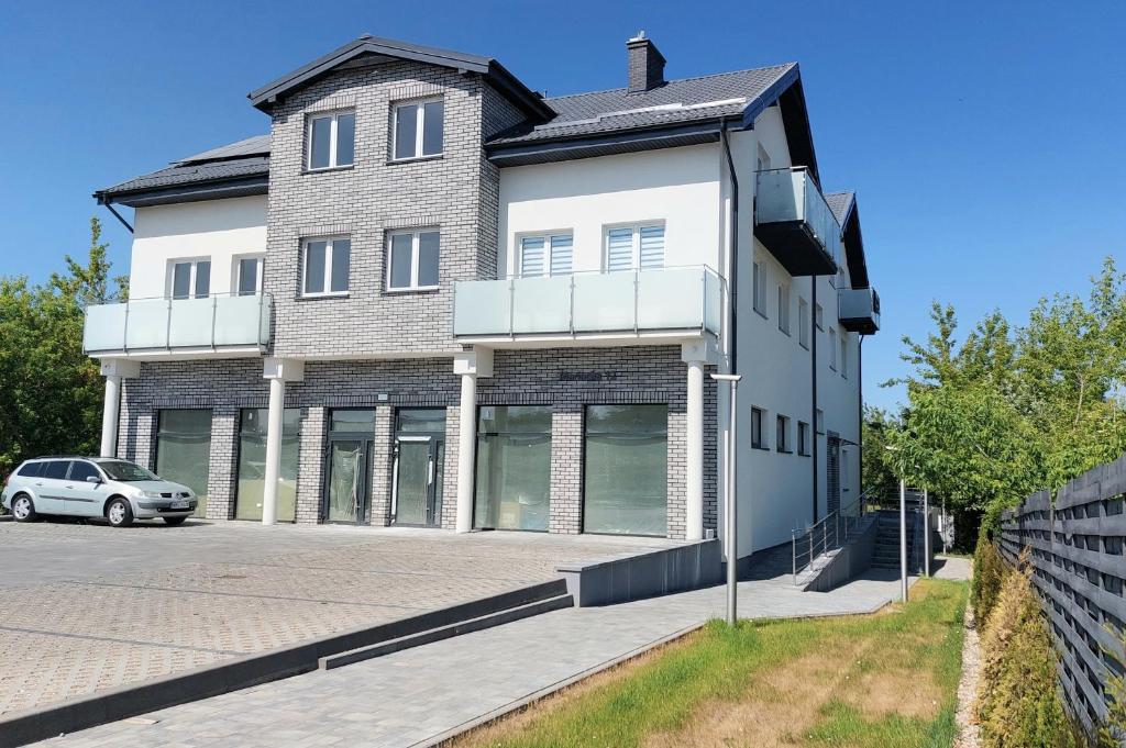 a building with a car parked in front of it at Apartament Mariacka in Mława