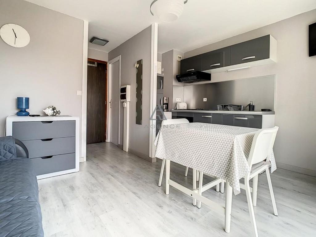 a kitchen and dining room with a table and chairs at Studio Cucq-Stella Plage, 1 pièce, 2 personnes - FR-1-236-84 in Stella-Plage