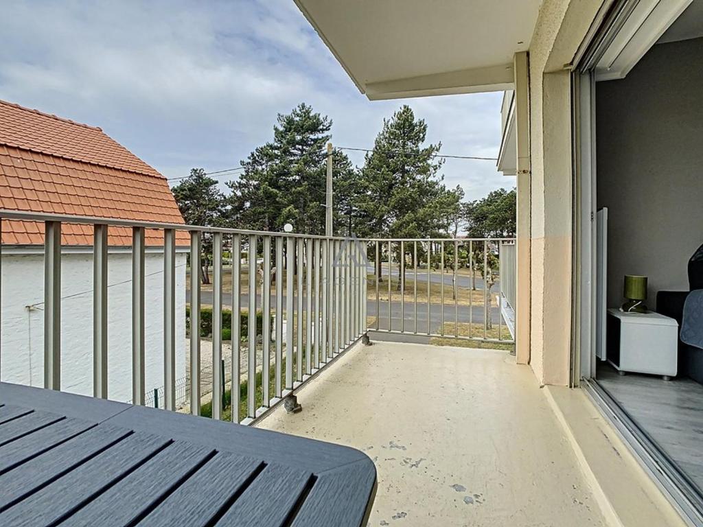 a balcony with a bench and a view of the water at Studio Cucq-Stella Plage, 1 pièce, 2 personnes - FR-1-236-84 in Stella-Plage