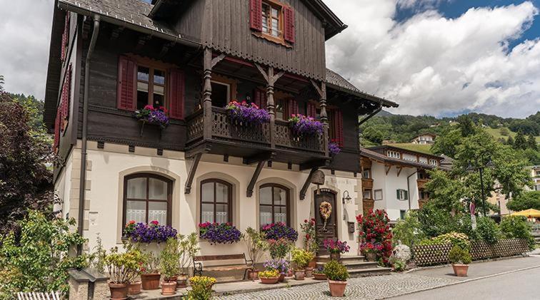 a large house with flowers in front of it at Haus an der Litz in Schruns-Tschagguns