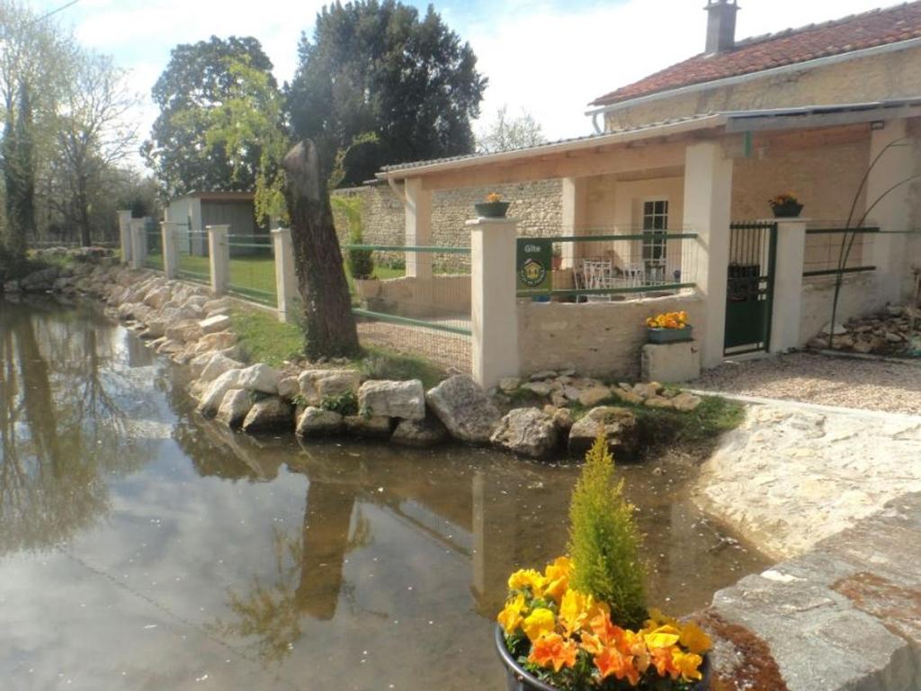 una casa con un estanque frente a una casa en Gîte Saint-Sulpice-de-Cognac, 3 pièces, 4 personnes - FR-1-653-221, en Saint-Sulpice-de-Cognac