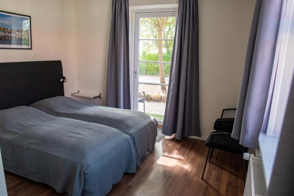 Postel nebo postele na pokoji v ubytování Nordgården Pension