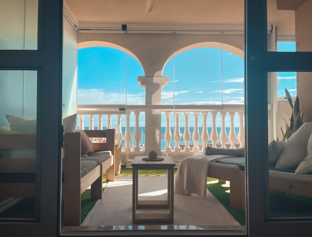 a room with a balcony with a view of the ocean at Kailua Dream in Almerimar