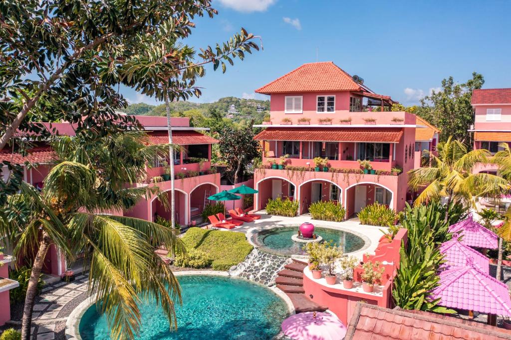 an aerial view of a pink building with a swimming pool at PinkCoco Uluwatu - Constant Surprises - for Cool Adults Only in Uluwatu