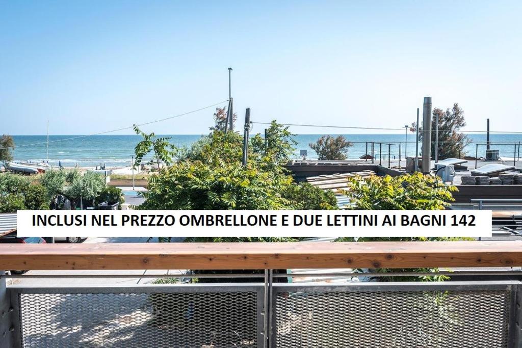 a sign on a fence in front of a beach at SE006 - Senigallia, bilocale sul mare con spiaggia in Senigallia