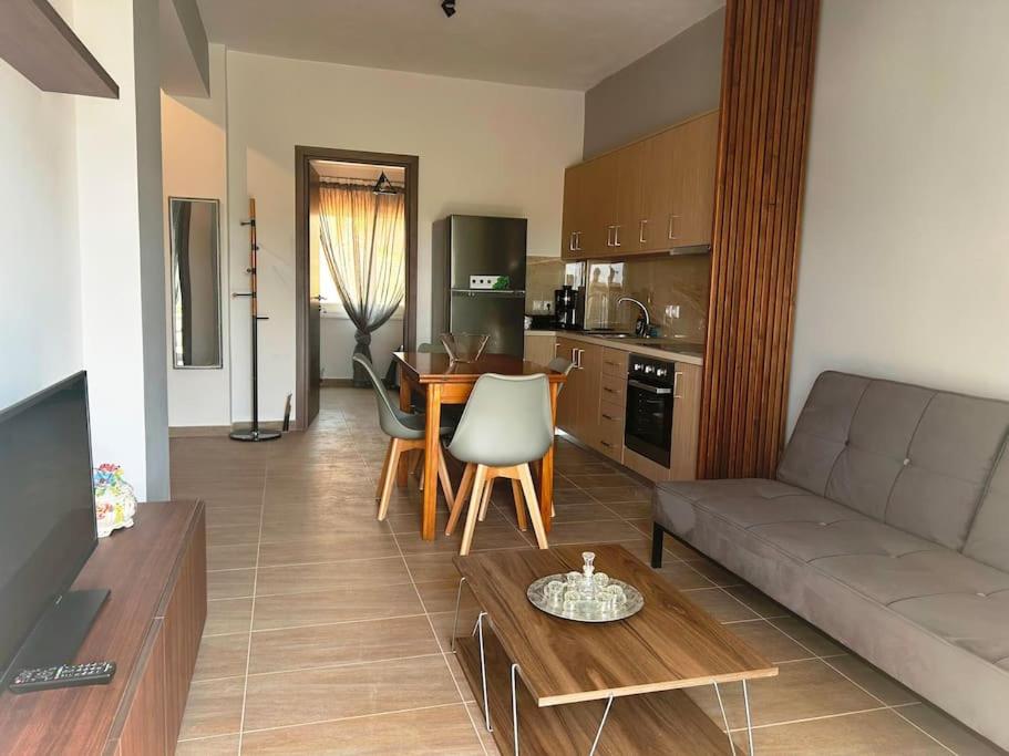 a living room with a couch and a table at Korina's Apartment in Daratso
