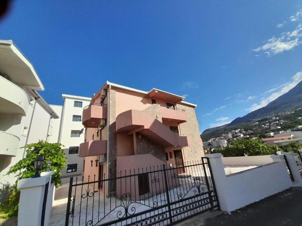 a building with a fence in front of it at Apartments Normannia in Dobra Voda